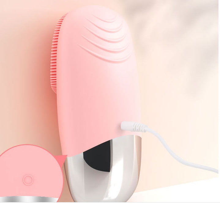 Sonic silicone facial cleansing brush — compact travel-friendly size in hand